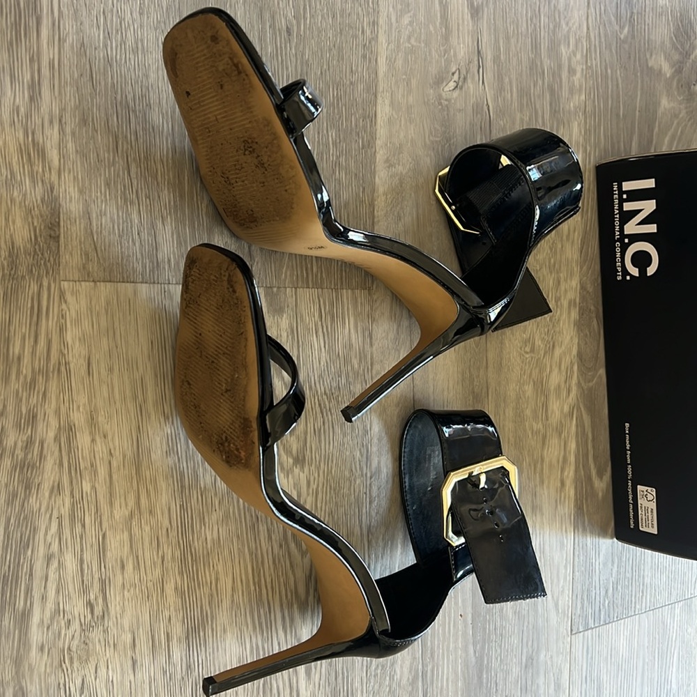High heels, black patent leather with gold buckle.